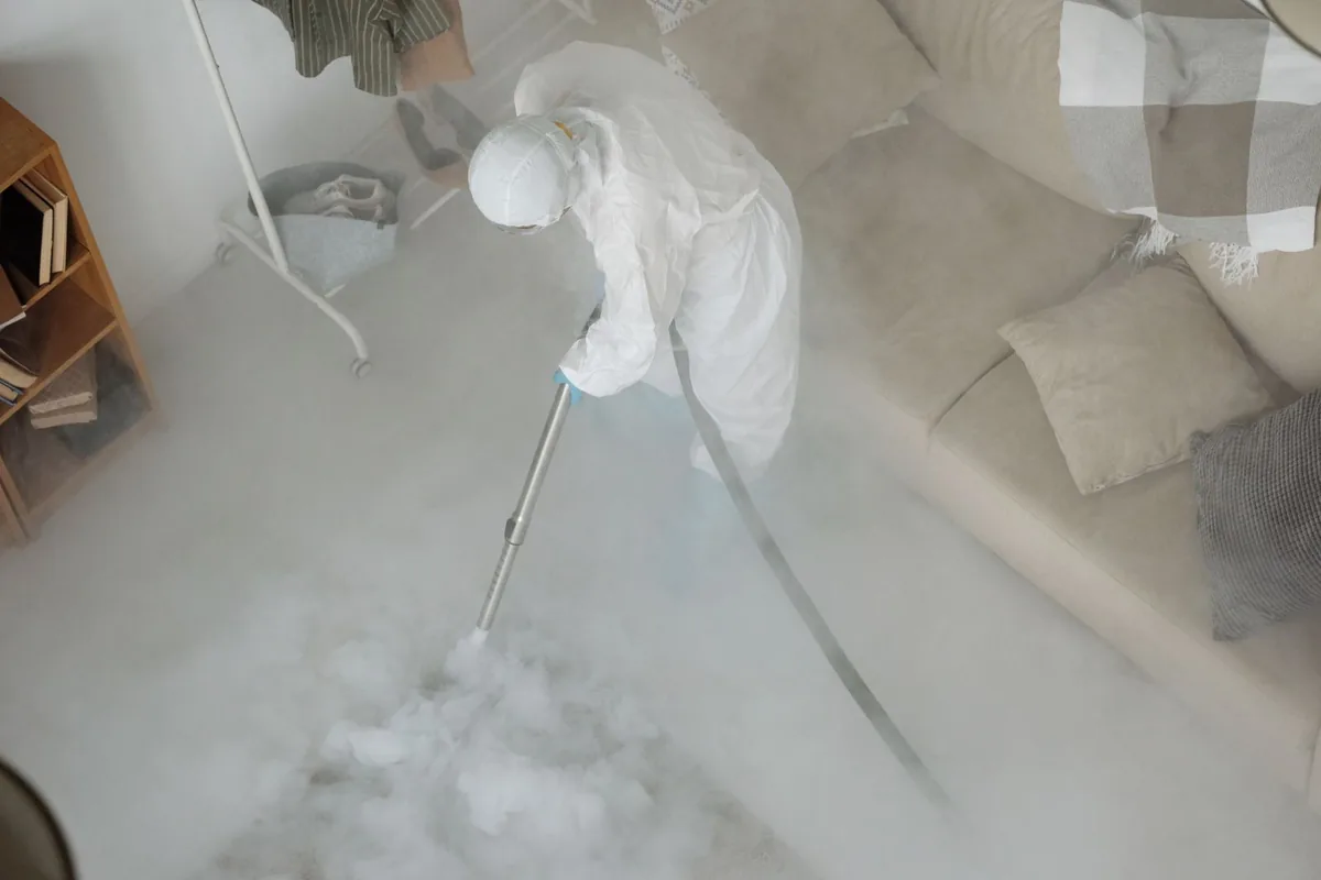 Biohazard cleanup technician in protective equipment, Taft Southwest, TX